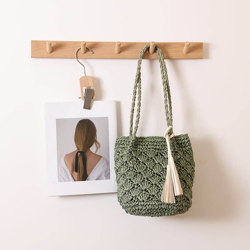 Close-up of green Tassel breeze woven shoulder bag for women
