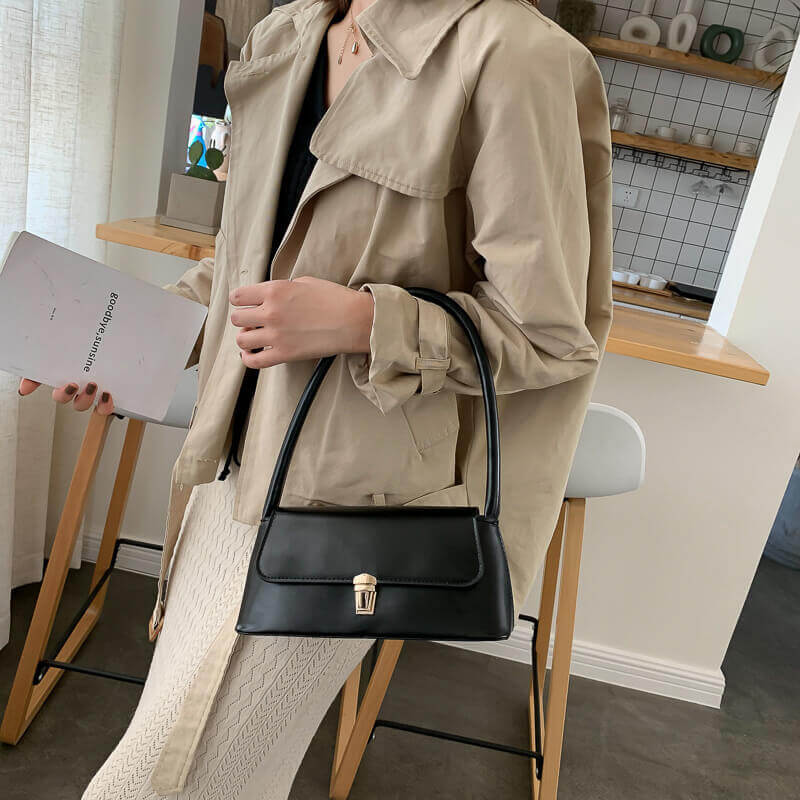 Model carrying black Charm French shoulder bag for women