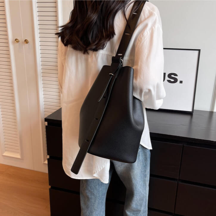 Model carying black Urbanmood fashion pu leather bucket bag for women