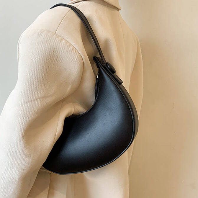Model carrying black Vintage dumpling shoulder bag for women