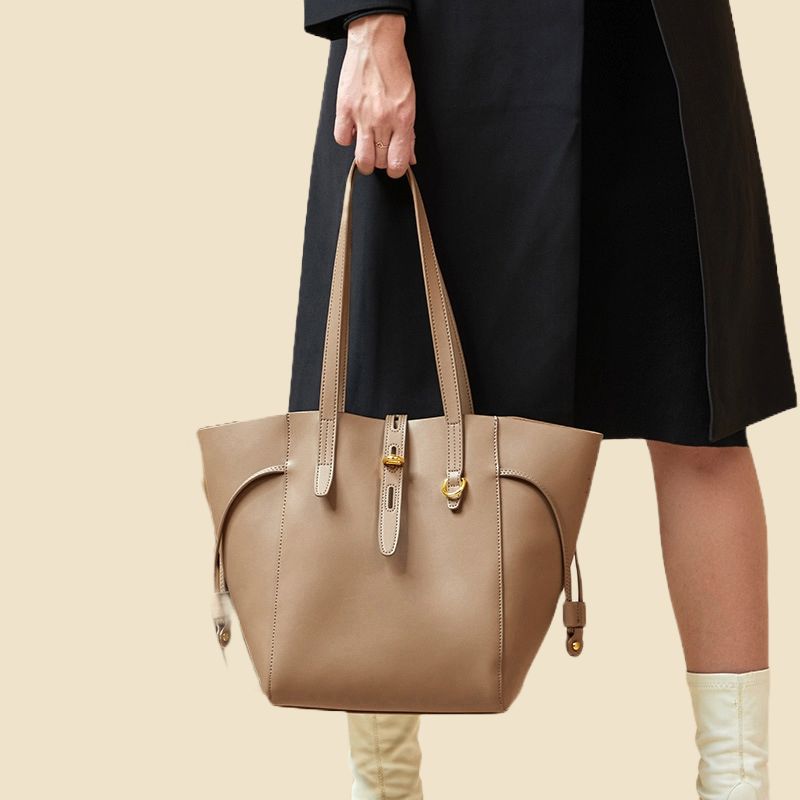 Model hand carrying Versatile elegance leather tote bag for women