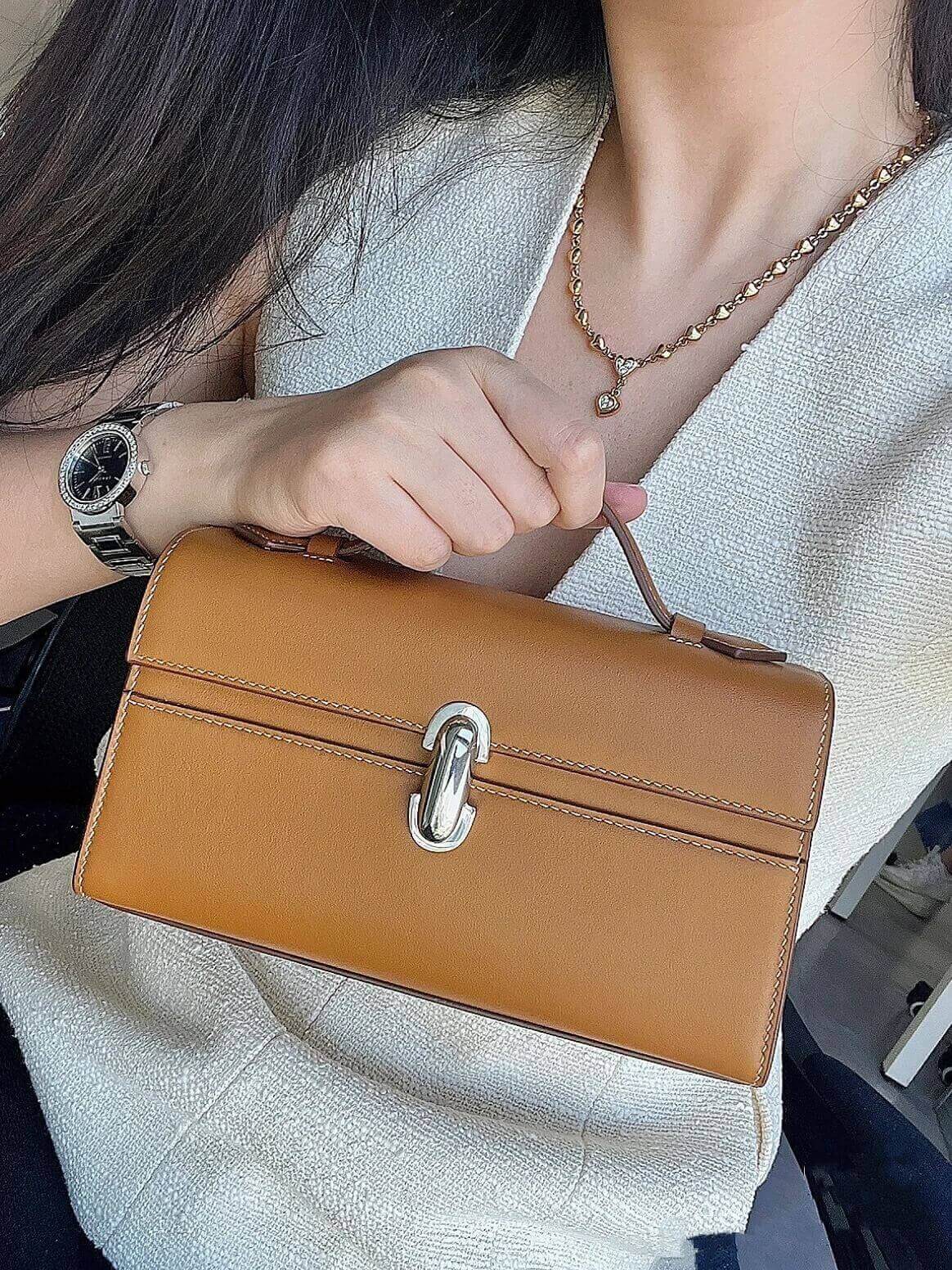 Model holding Modeedge leather satchel for women