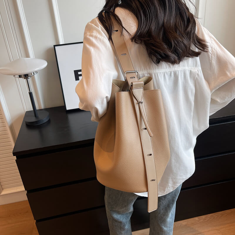 Model holding windbreaker gray Urbanmood fashion pu leather bucket bag for women