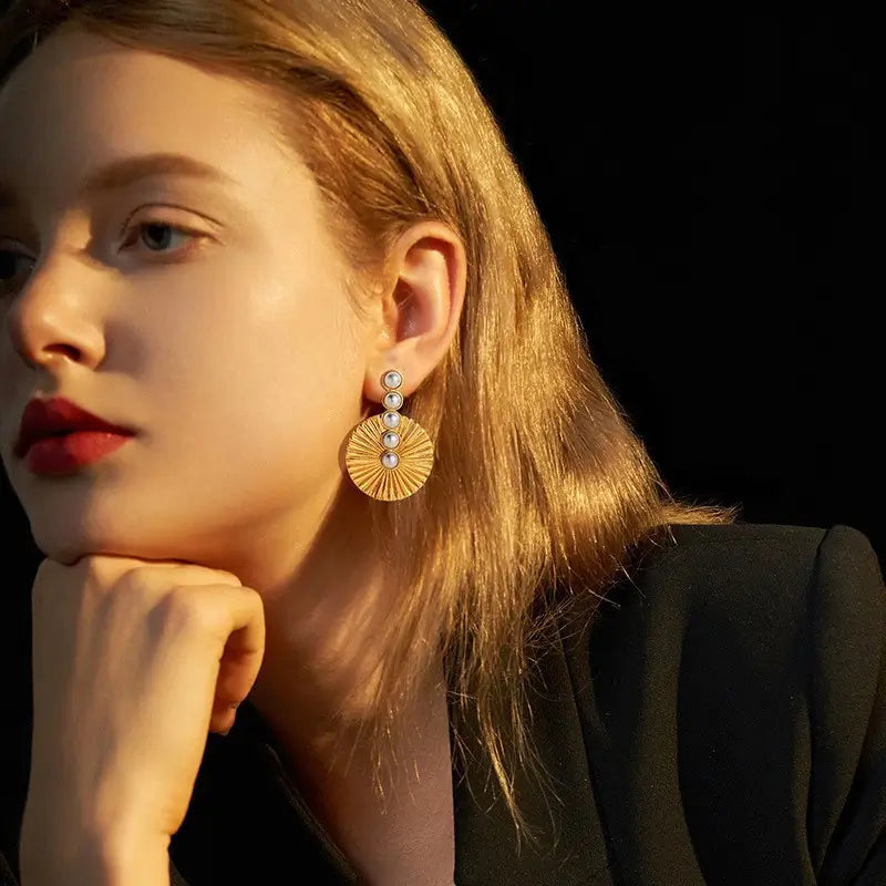Model wearing Pearluxe gold drop earrings for women