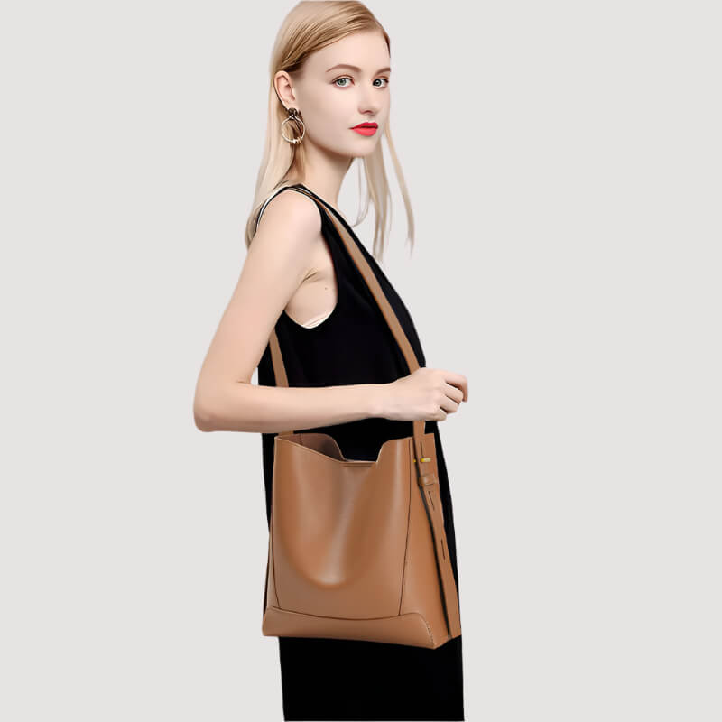 Model carrying caramel Luxe leather bucket bag for women